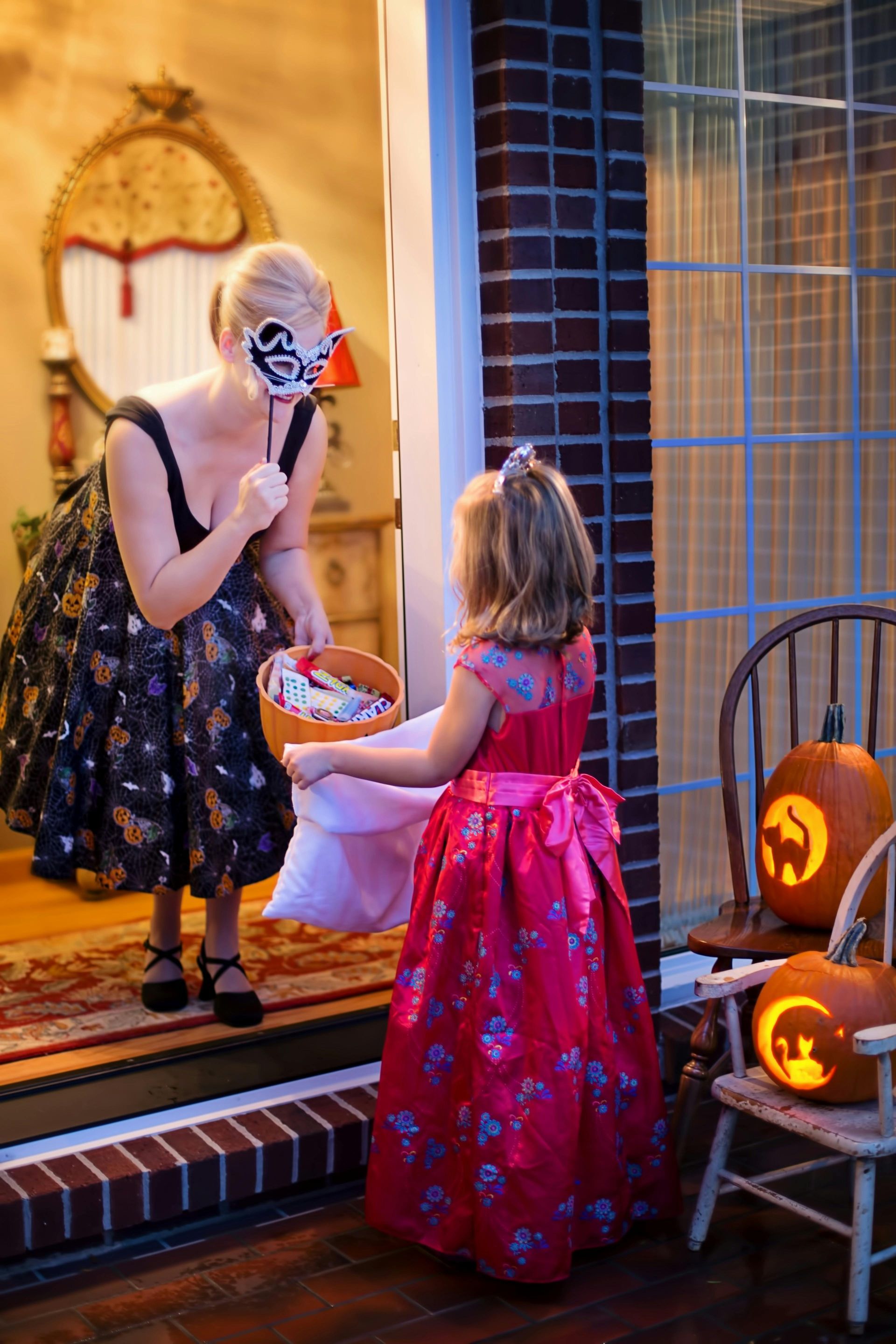 Woman and child trick-or-treating for Halloween