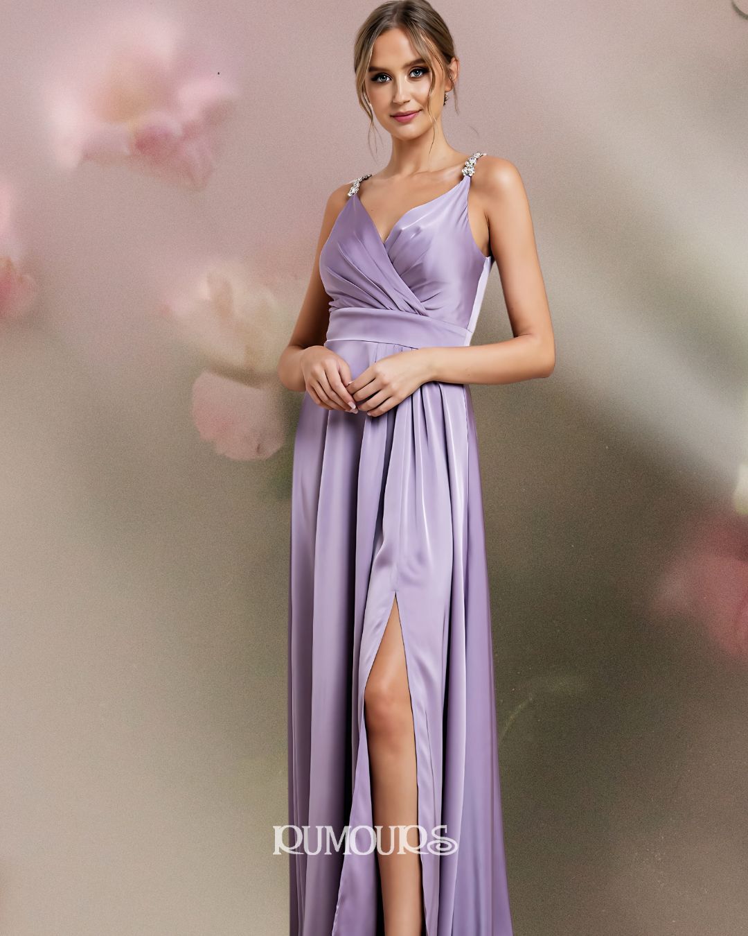 Woman in lilac formal dress with slit, standing near a wall with soft pink and green hues.