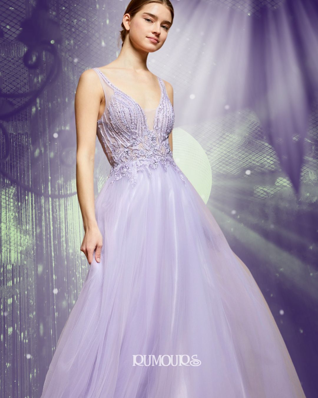 Woman in a lavender gown with beaded bodice, smiling, posed against a hazy purple backdrop.