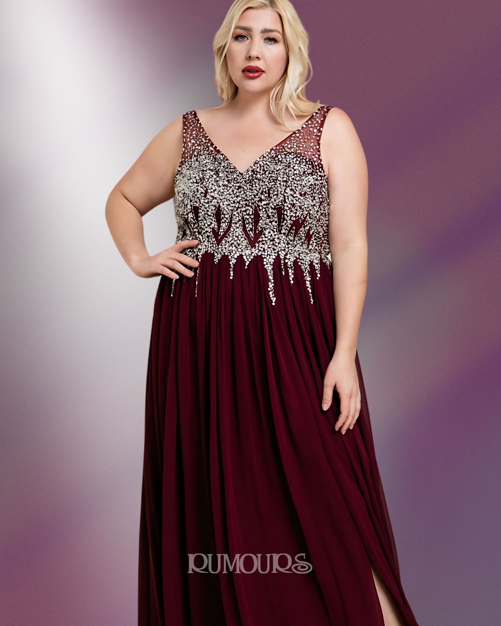 Woman in a burgundy formal gown with white embellished bodice, standing against a purple background.