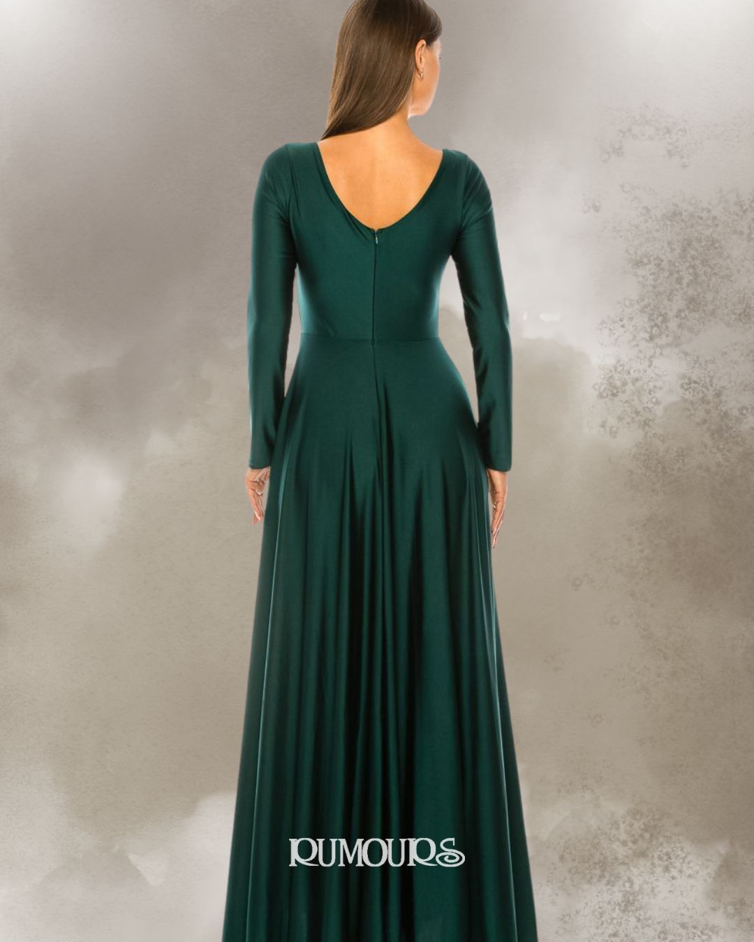 Woman in a long, dark green dress with long sleeves and a V-neck, standing against a blurred background.