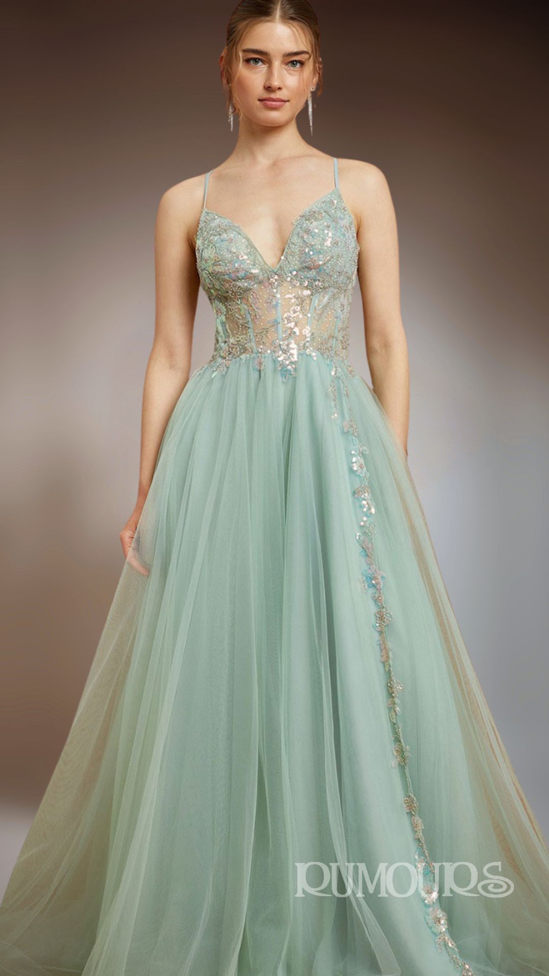 Woman in a light green formal gown with a beaded bodice and spaghetti straps.