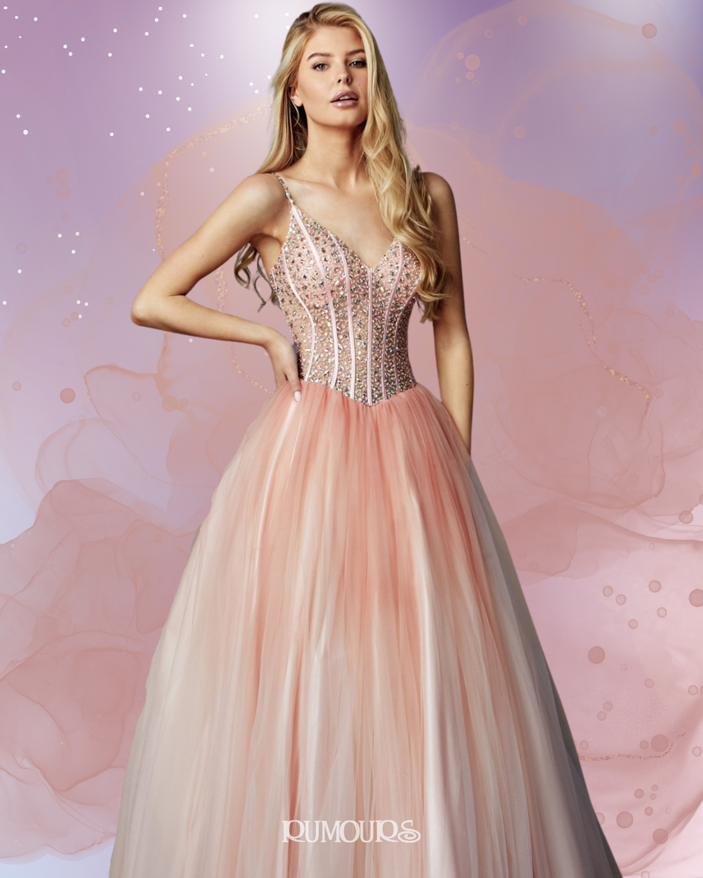Woman wearing a pink ballgown with a beaded bodice, standing in front of a watercolor background.