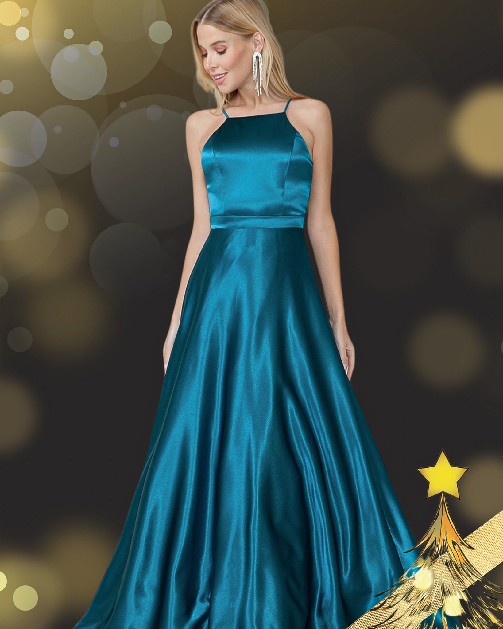 Woman in teal satin gown smiles, posing near festive decorations, gold star and bokeh effect in background.