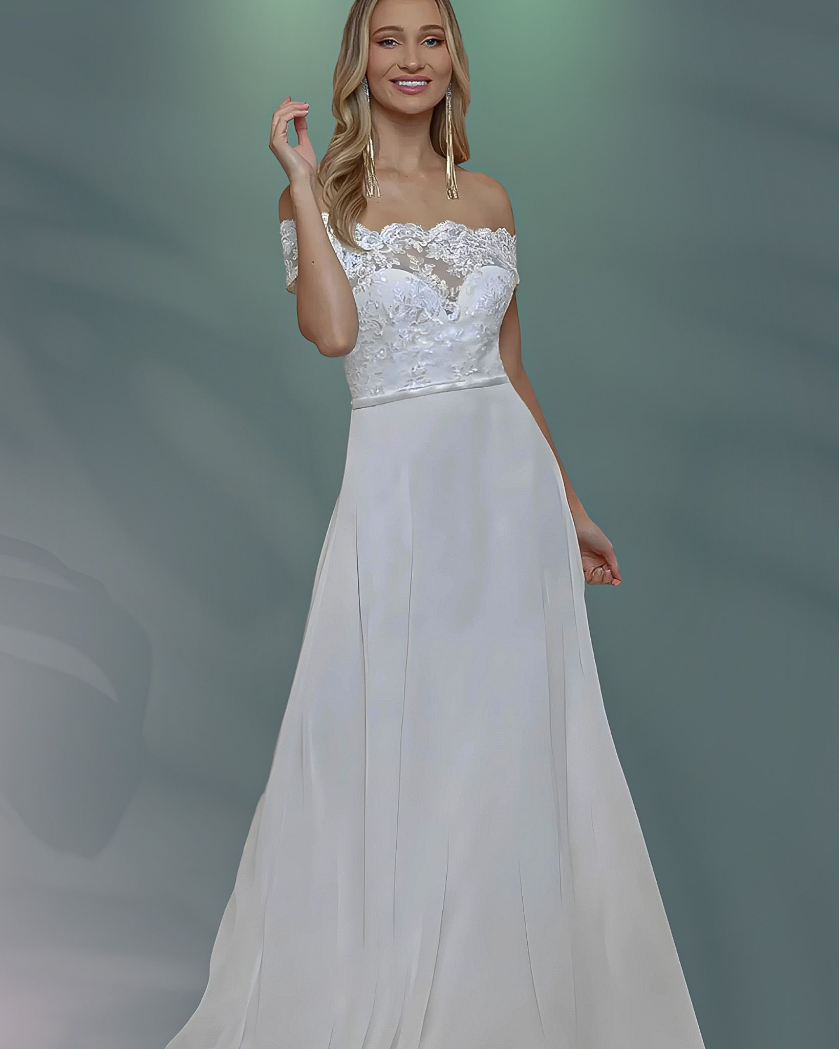 Woman in white off-the-shoulder dress smiles. The dress has a lace bodice and a flowing skirt; background is green.