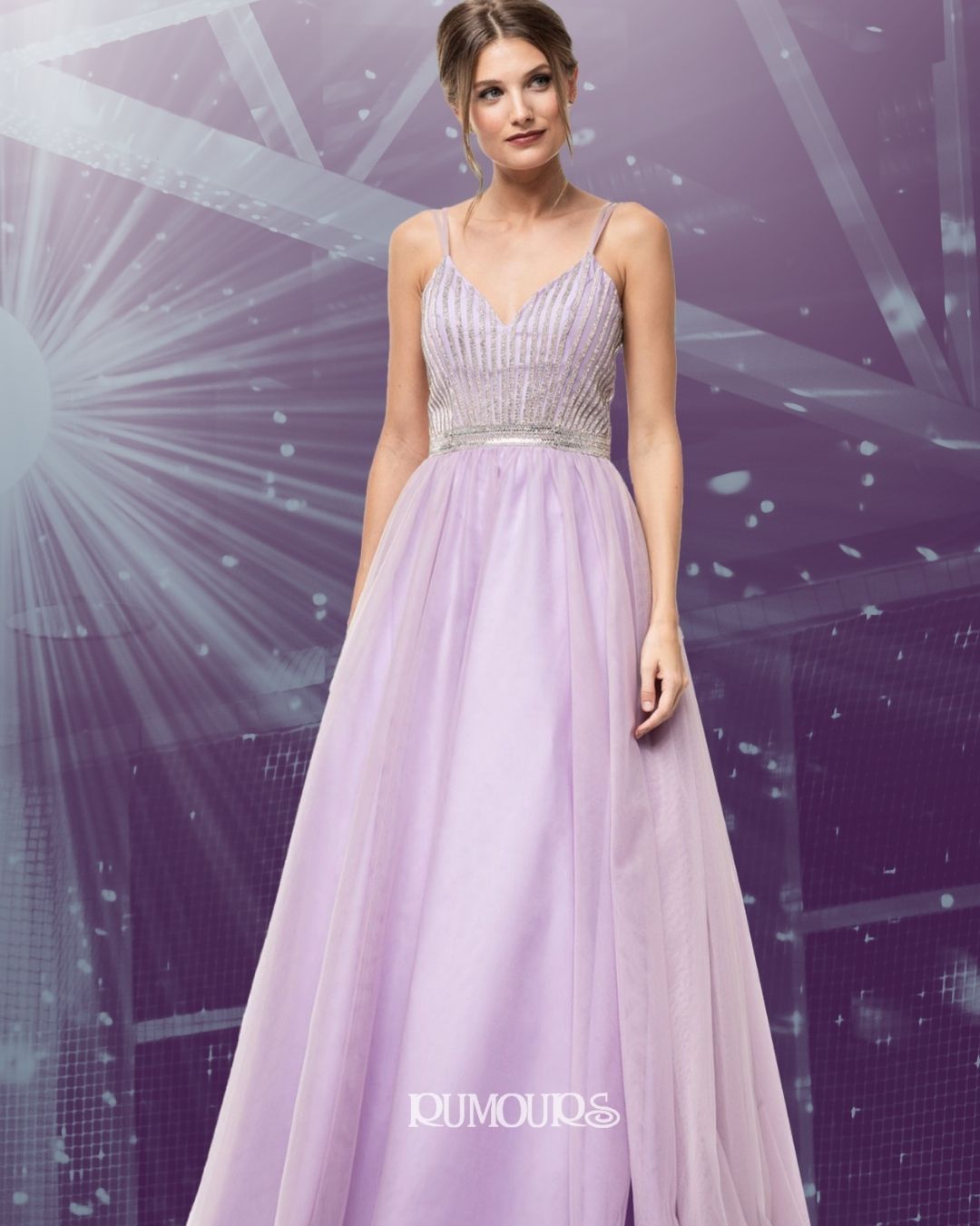 Woman wearing a light purple formal gown with beaded bodice, standing in front of a purple backdrop.