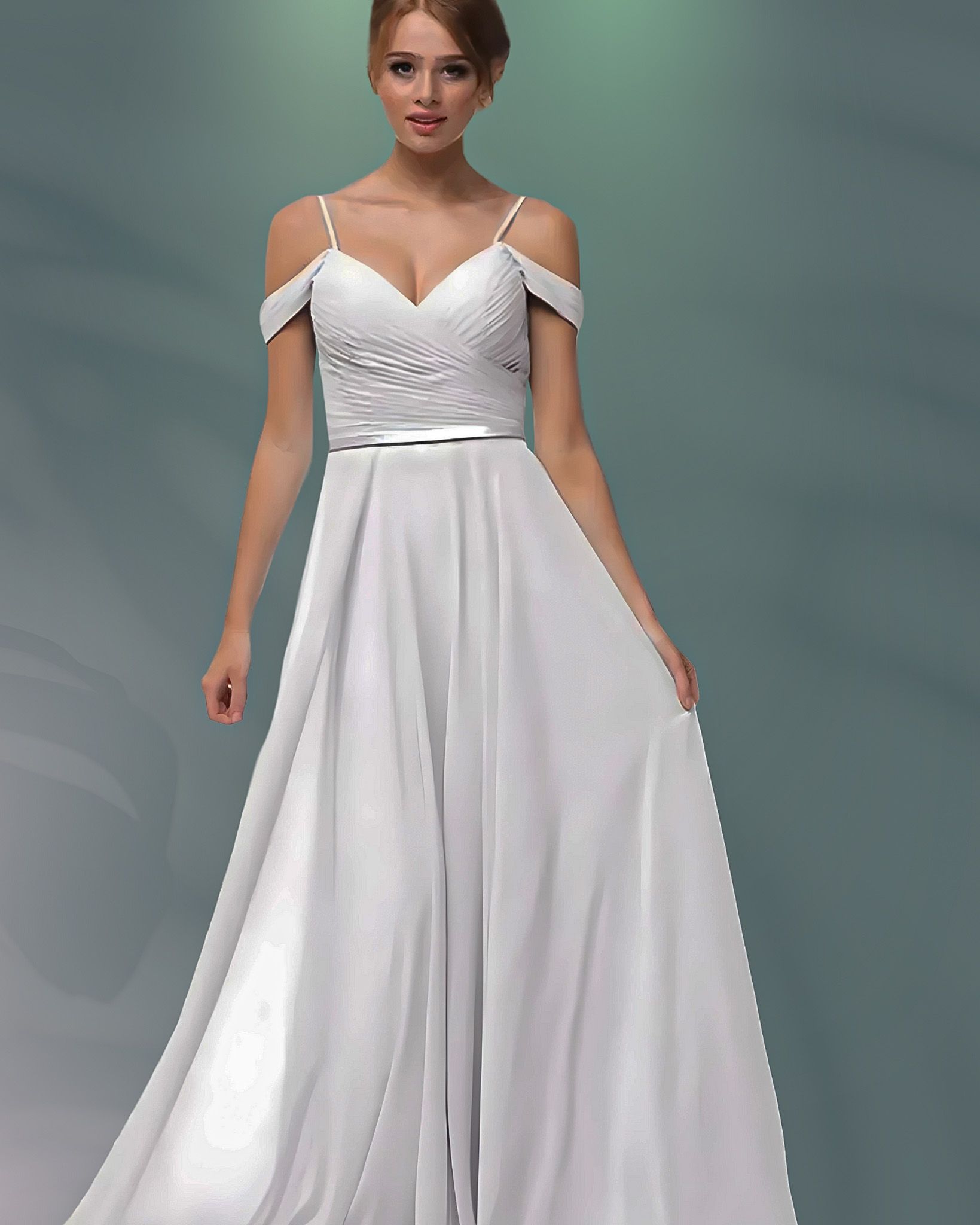 Woman in a white off-the-shoulder gown with thin straps and a silver belt, posed against a green background.