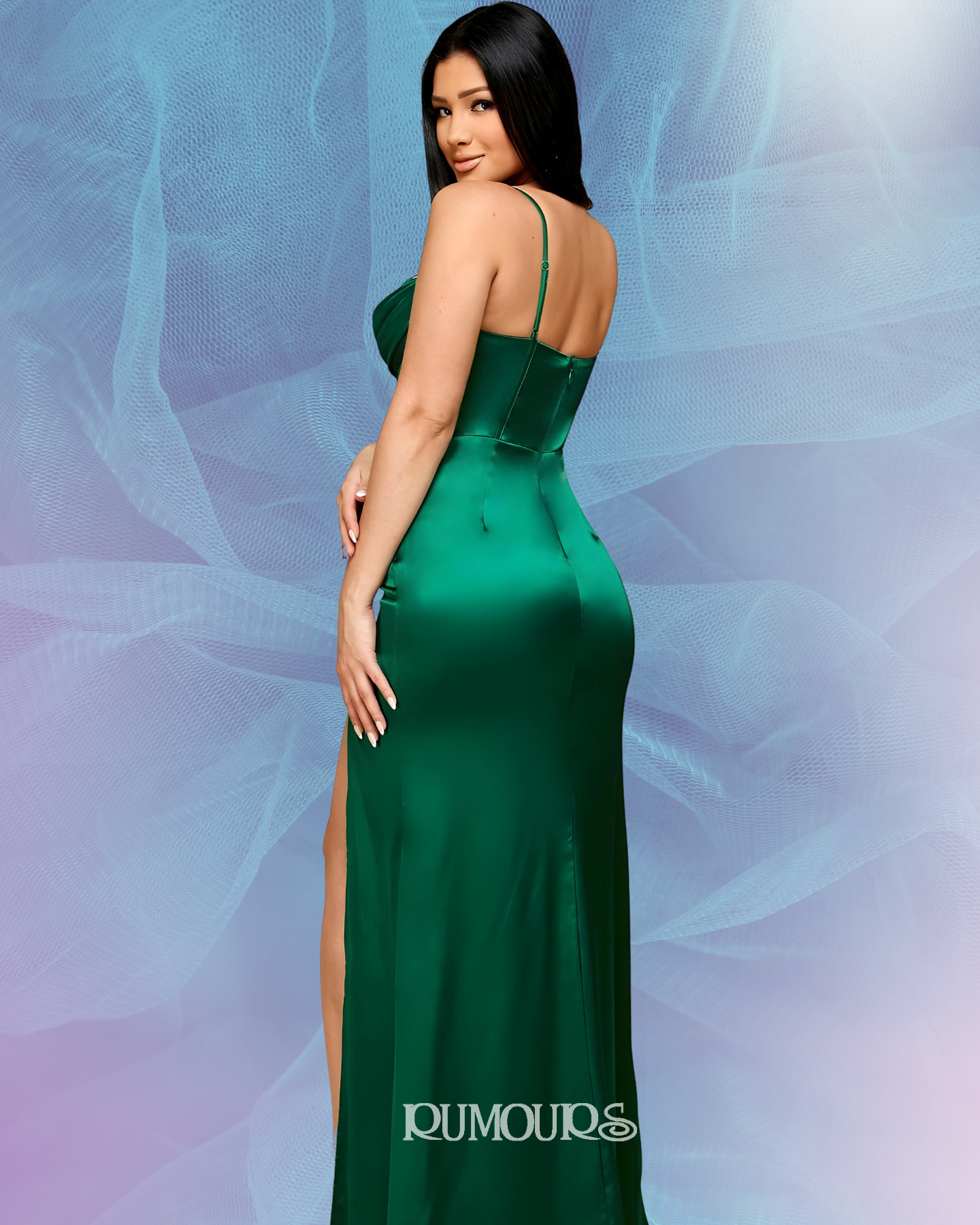 Woman in a green satin gown, looking over her shoulder. The dress has a high slit.