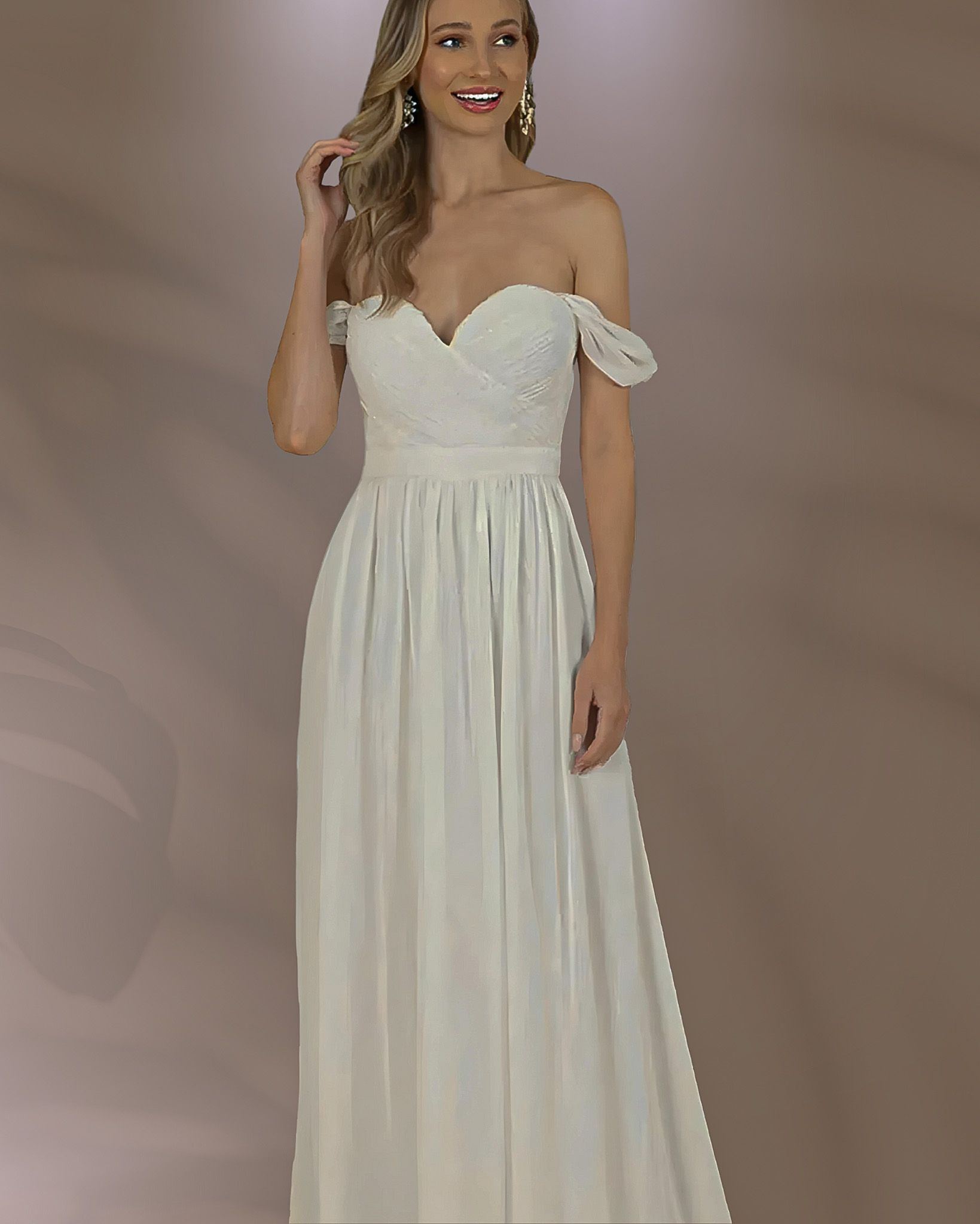 Woman in off-the-shoulder white wedding dress, standing, looking at the viewer, light background.