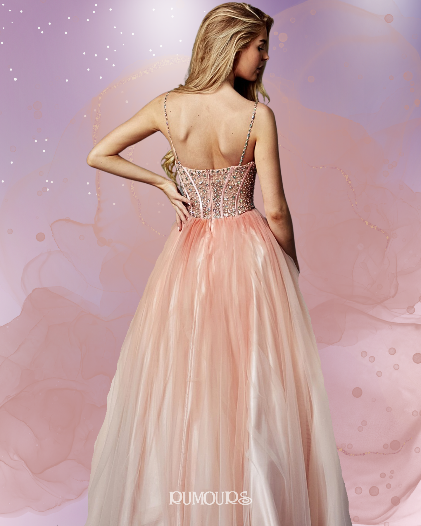 Woman in a pink formal gown, back view, standing in front of a soft pink background.