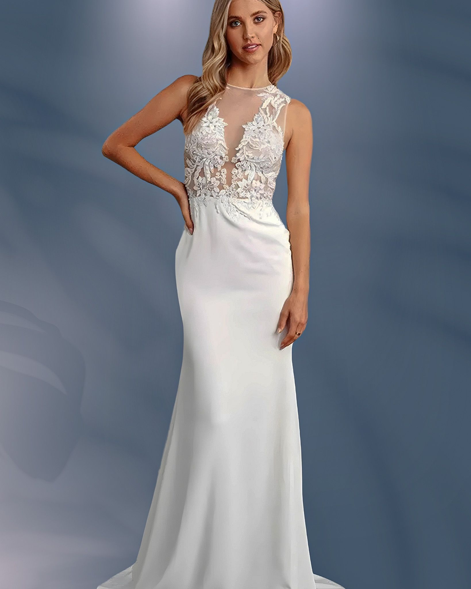 Woman in a white wedding dress with a sheer neckline, posing with hand on hip.