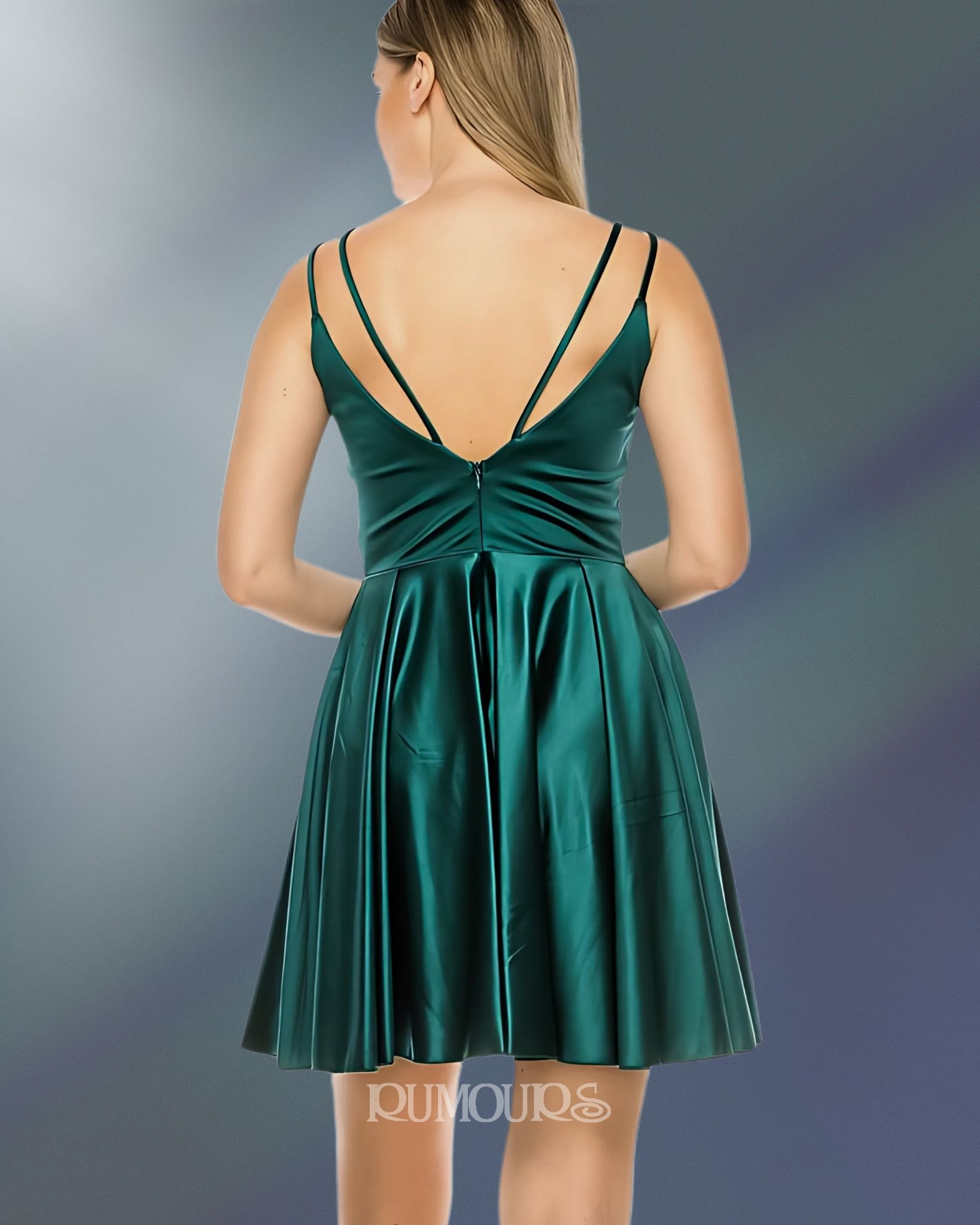 Woman in green dress with spaghetti straps.