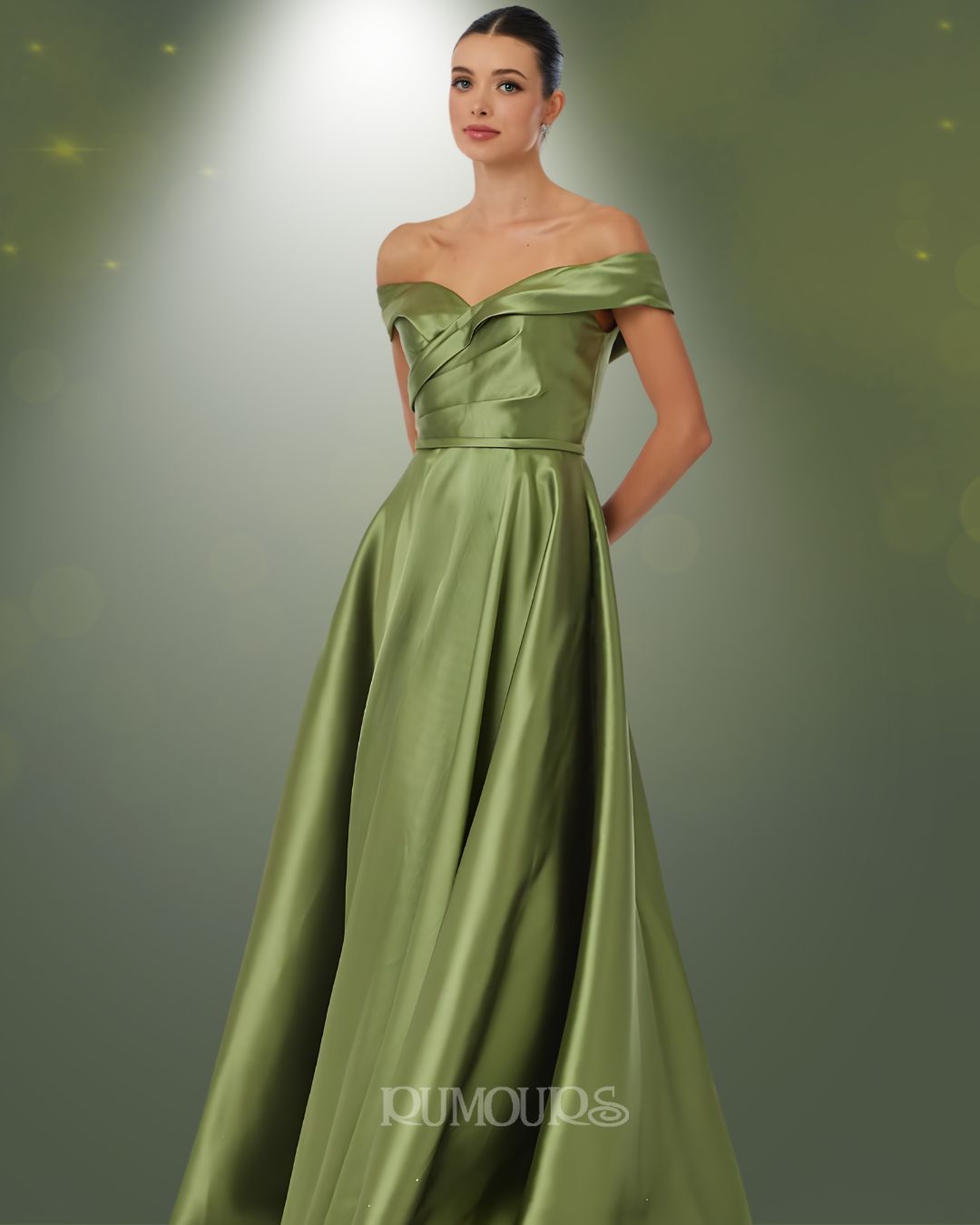 Woman in olive green off-shoulder gown, posing in front of a soft, gradient background.