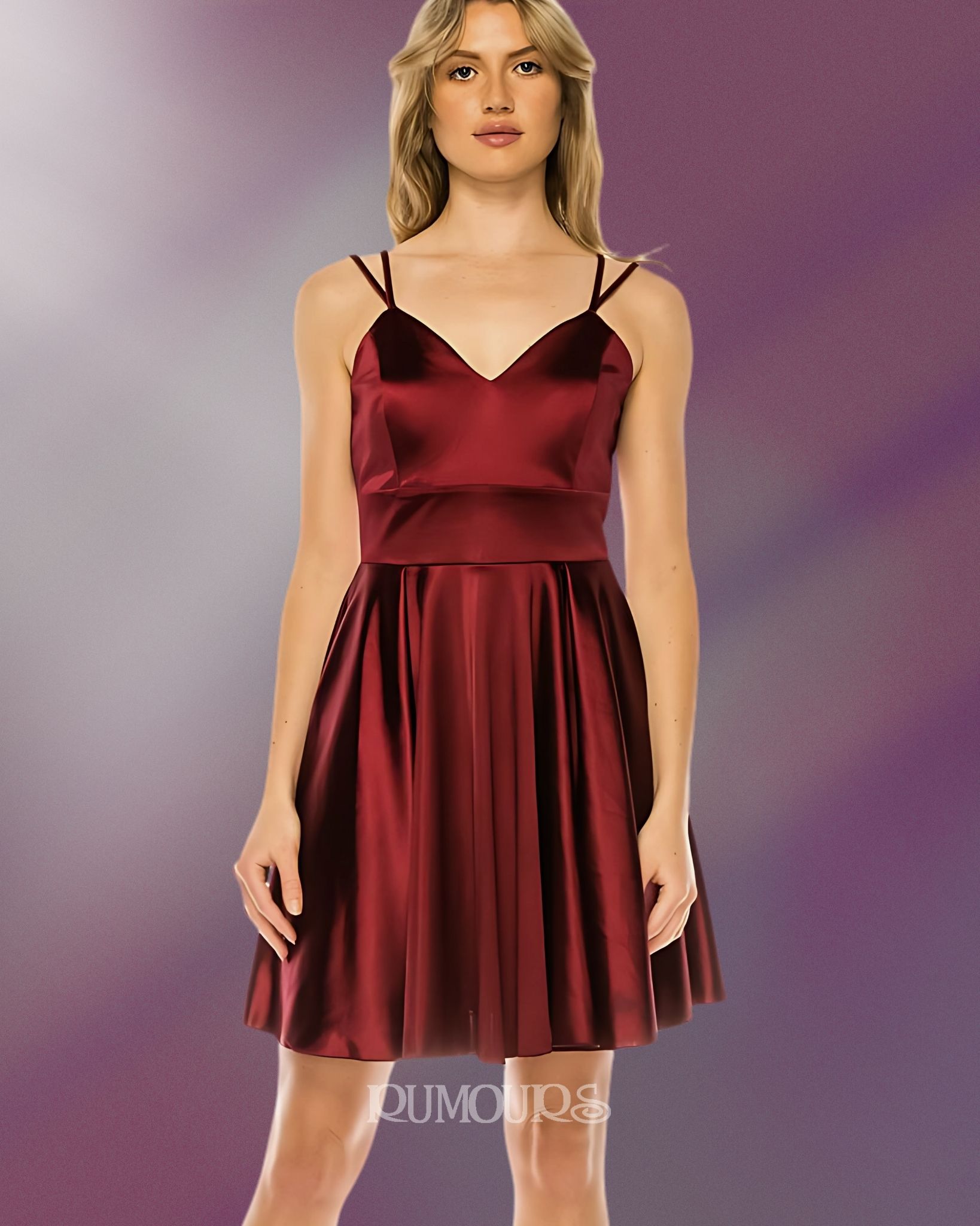 Woman in a burgundy satin cocktail dress with spaghetti straps.