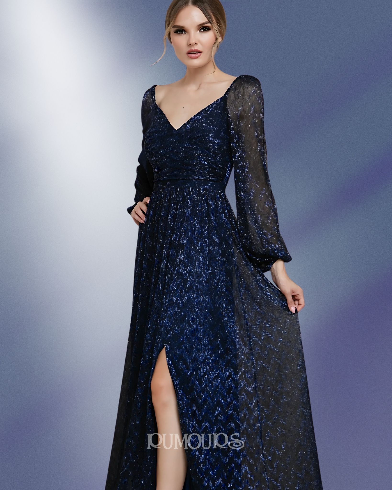 Woman in a navy sequined gown with long sheer sleeves, a thigh-high slit, and a plunging neckline.
