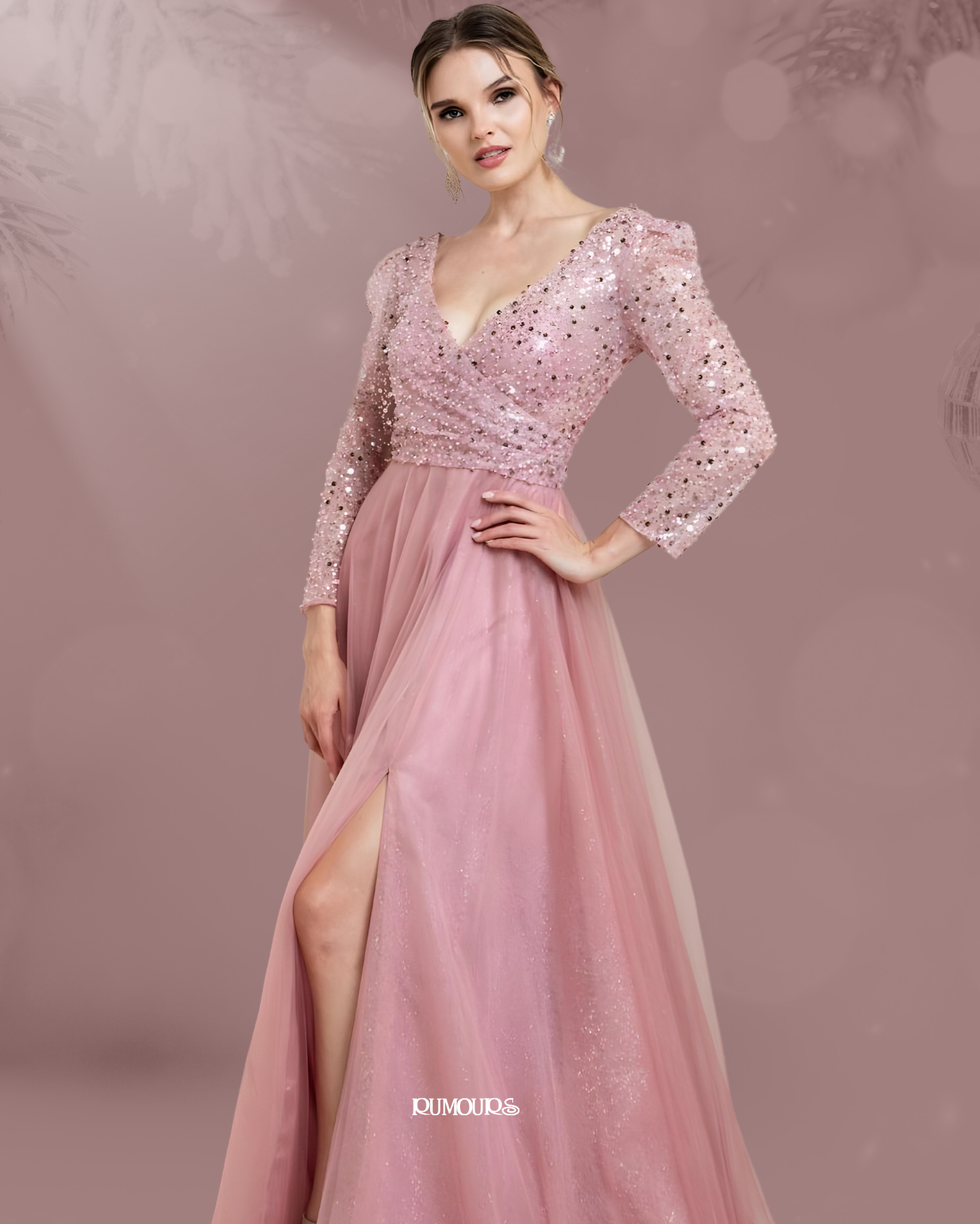 Woman in a pink, sequined formal dress with a high slit, posing indoors.