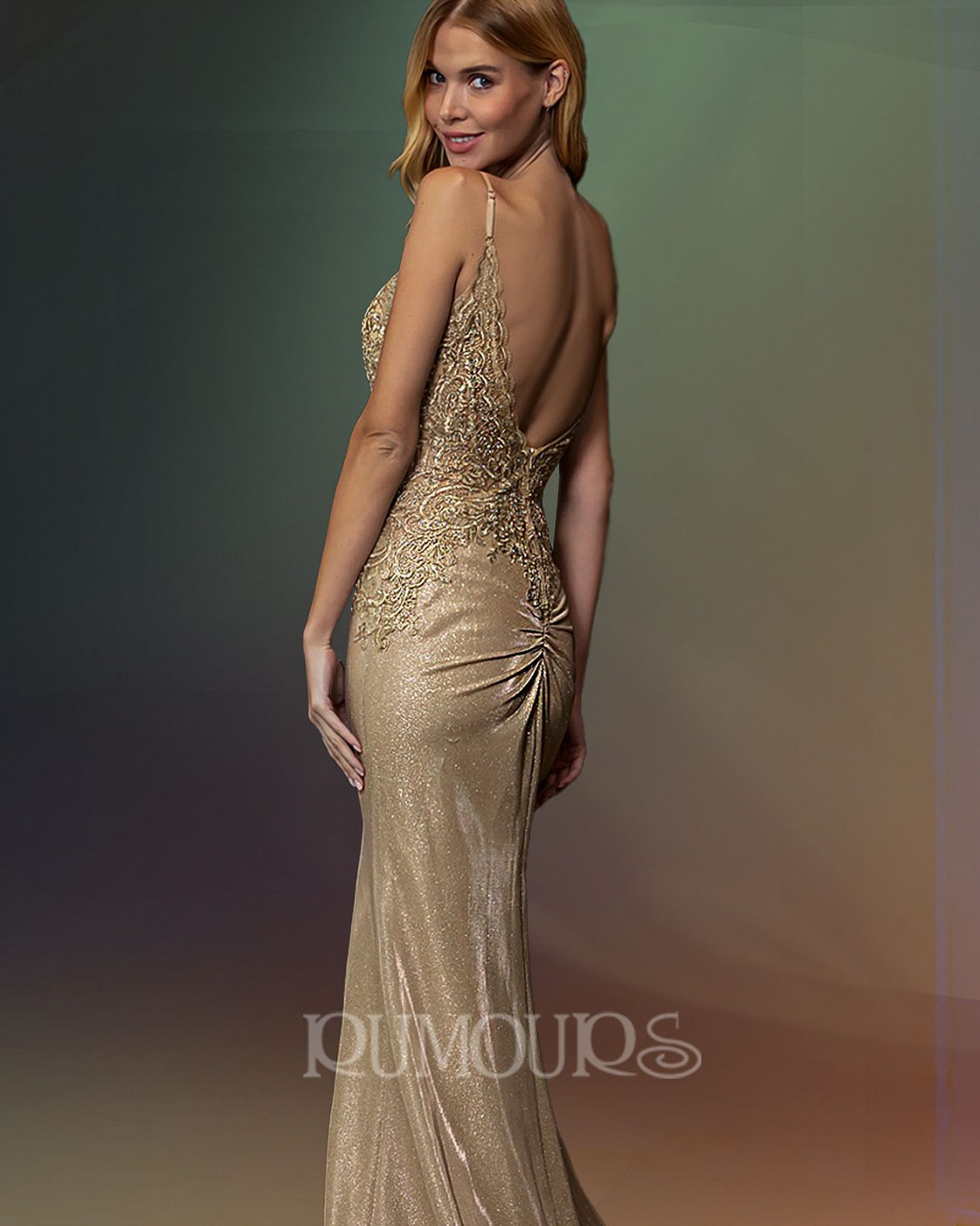 Woman in a gold sequined gown, backless, poses.