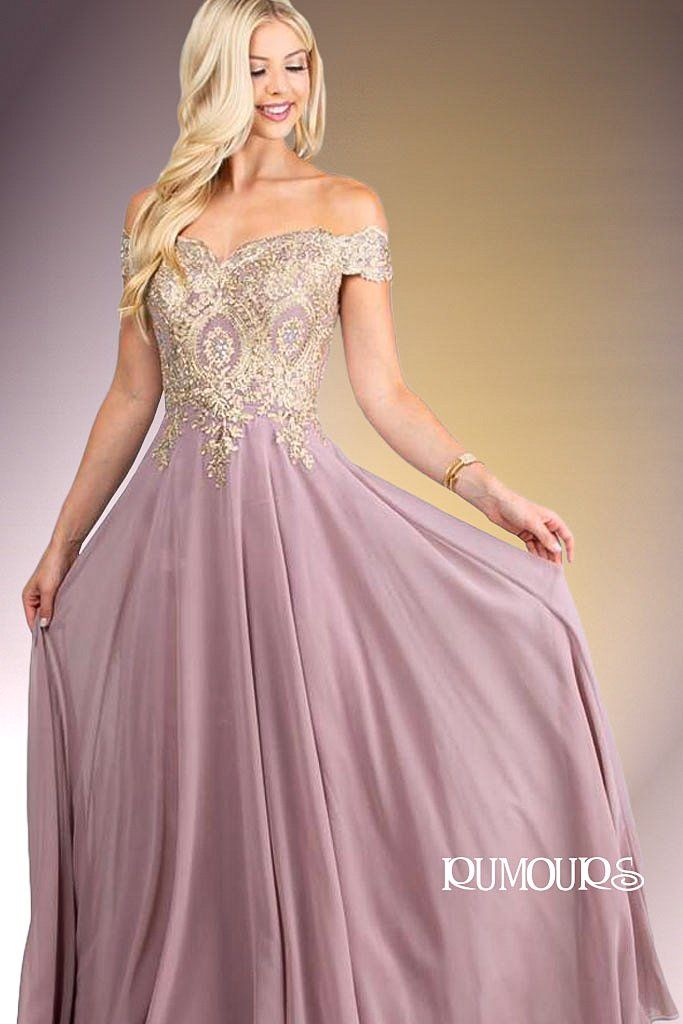 Woman in a formal purple gown with gold embroidered bodice, off-the-shoulder neckline, smiling.