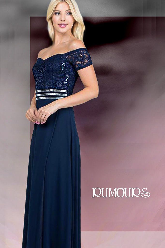Woman in navy off-shoulder evening gown with sequined bodice and silver waist detail.