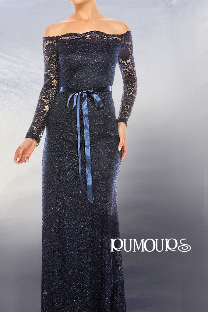 Woman in a navy off-the-shoulder lace gown with long sleeves and a ribbon belt.