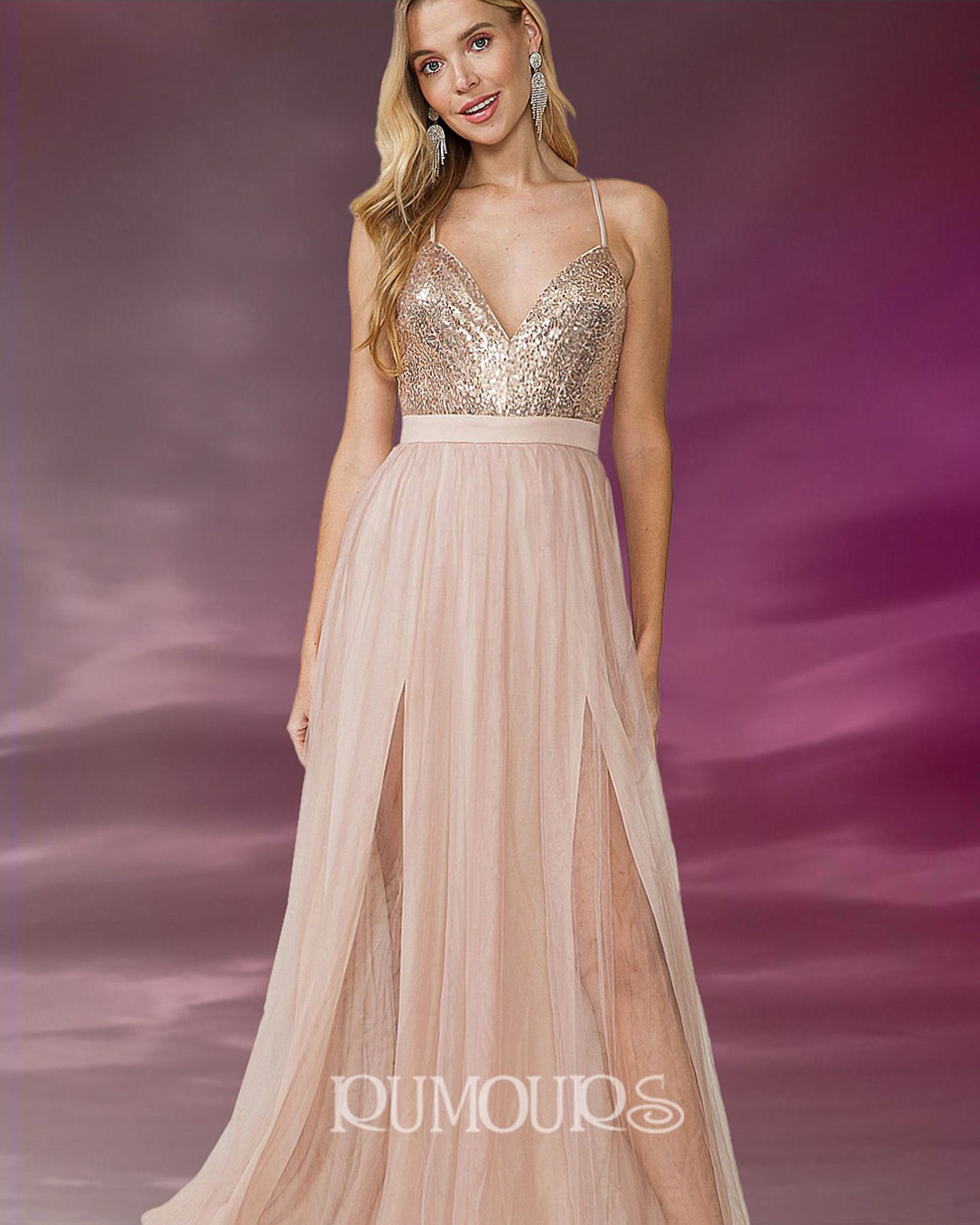 Woman in a sparkly gold top and a flowing, peach-colored skirt with high slits.