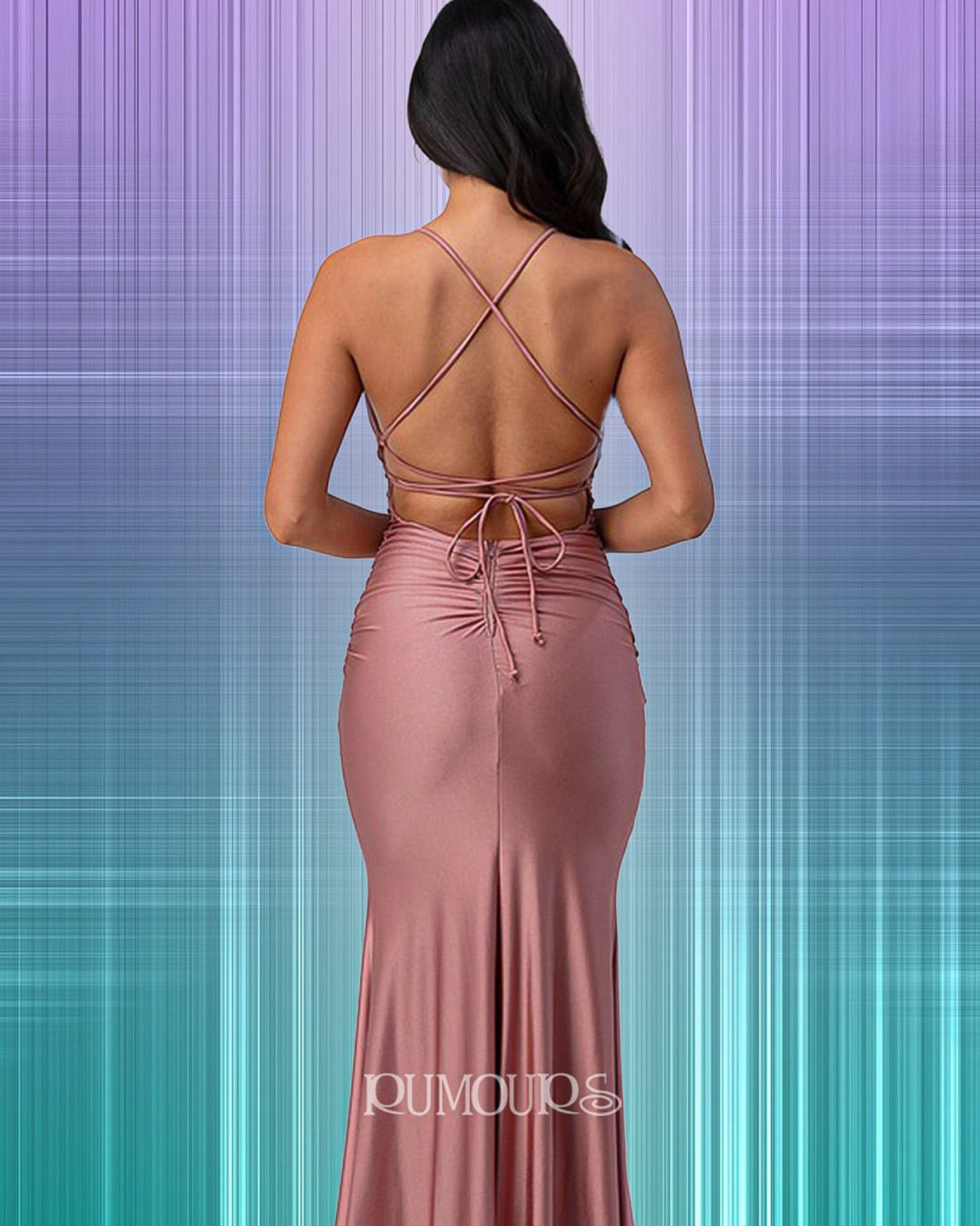 Woman in a mauve-colored formal dress with an open back and crisscross straps.