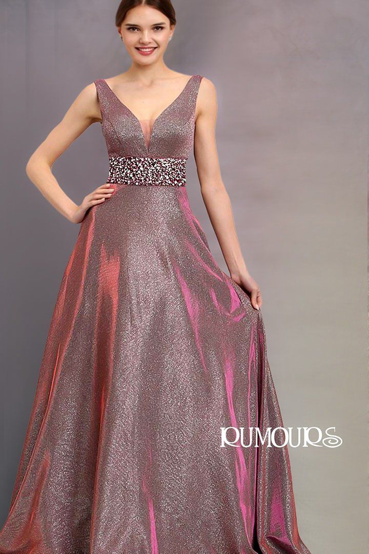Woman in a sparkling pink gown with a V-neck and embellished waist.