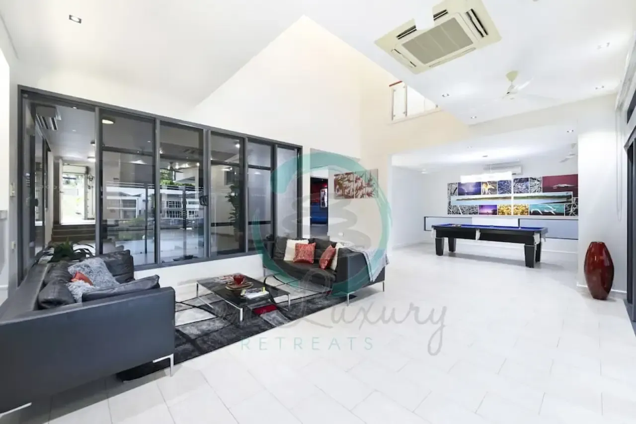A Living Room With a Pool Table and a Couch — Zen Luxury Retreats in Darwin City, NT
