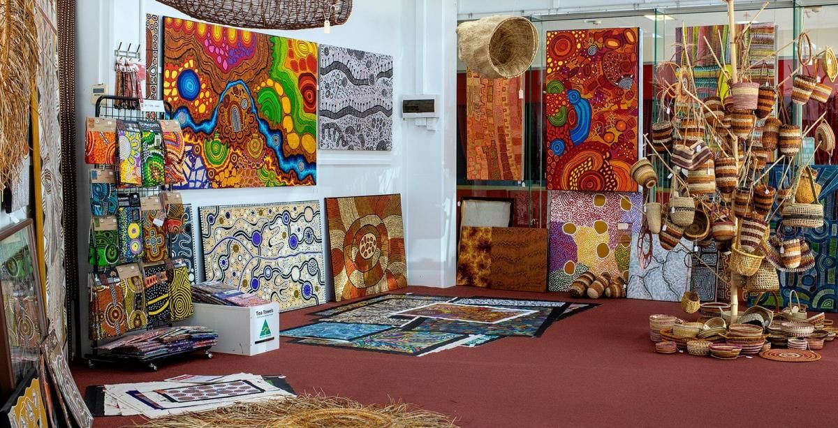 A room filled with lots of colorful paintings and rugs.