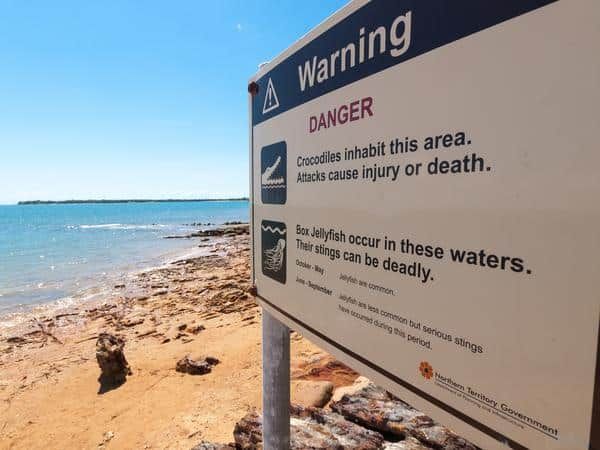 A Warning Sign on A Beach Says that Crocodiles Inhabit This Area — Zen Luxury Retreats in Darwin City, NT