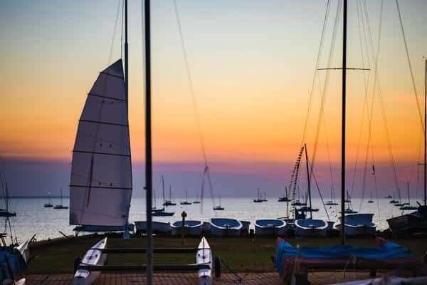 a Group of Sailboats Are Docked in a Harbor at Sunset — Zen Luxury Retreats in Darwin City, NT