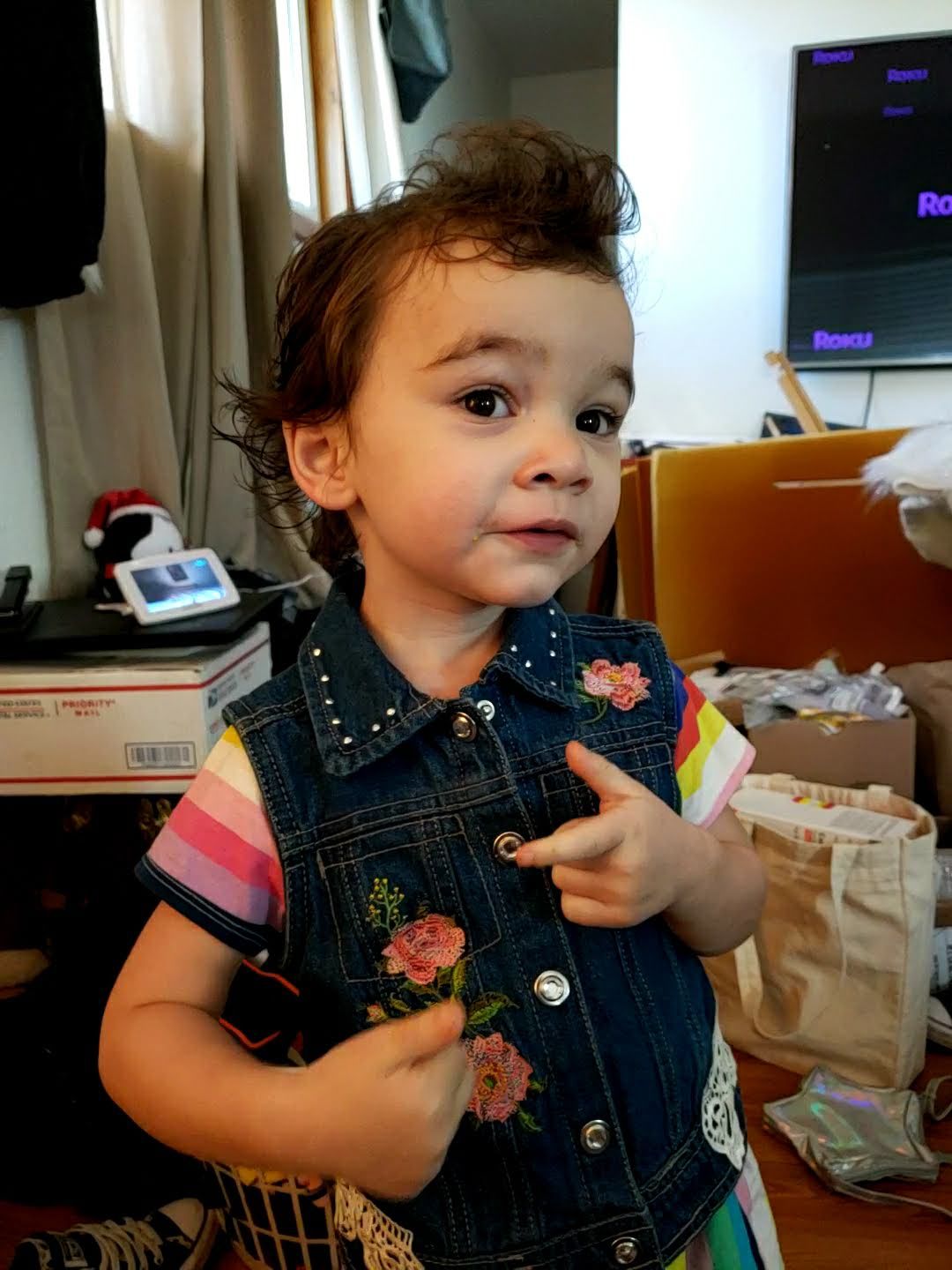 People signing documents at a table; one person points at a line.