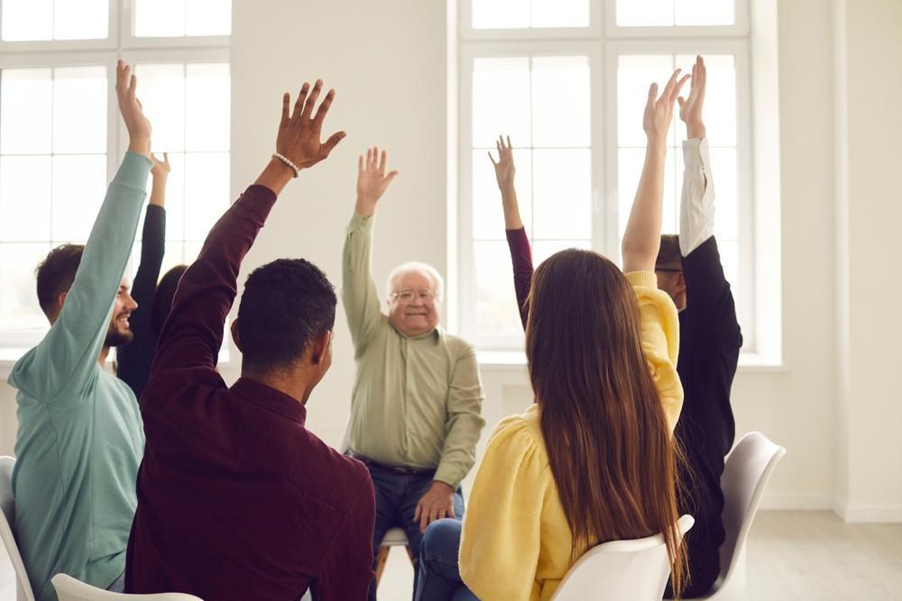 Group of People Are Sitting in a Circle With Their Hands in the Air — Serenity Strides in Redbank Plains, QLD