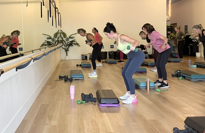 A group of women doing fitness with weights at Studio One FIt