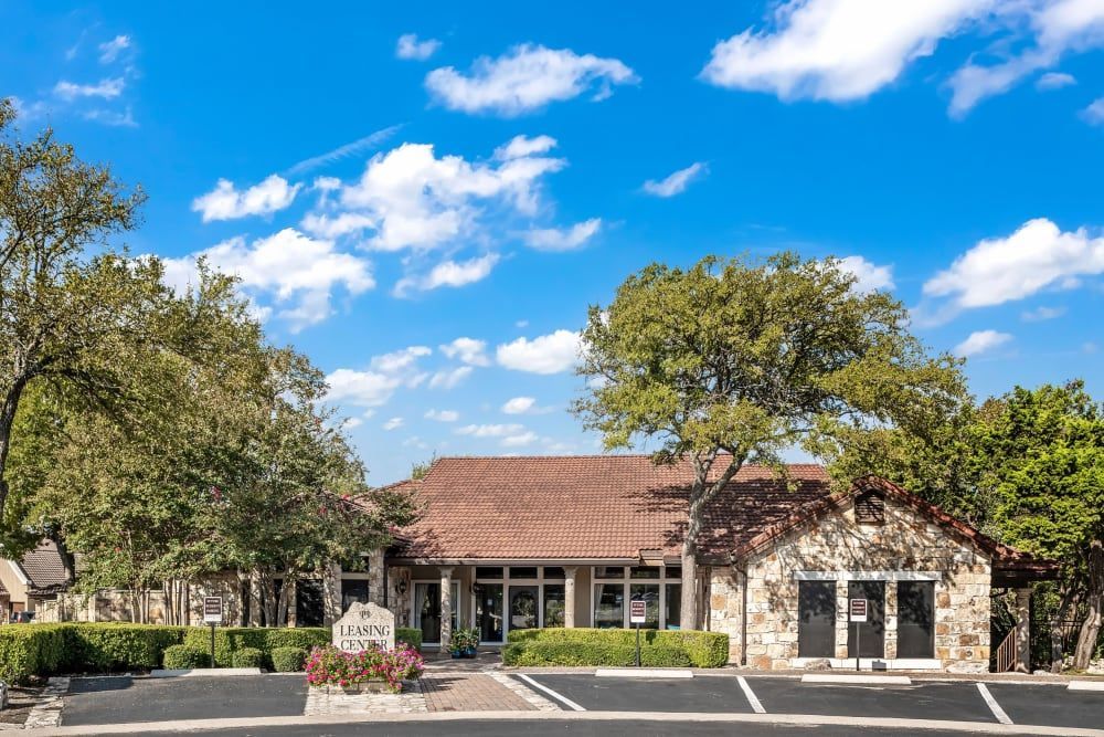 A large building with a lot of windows and trees in front of it at Marquis at Caprock Canyon in Austin, TX.