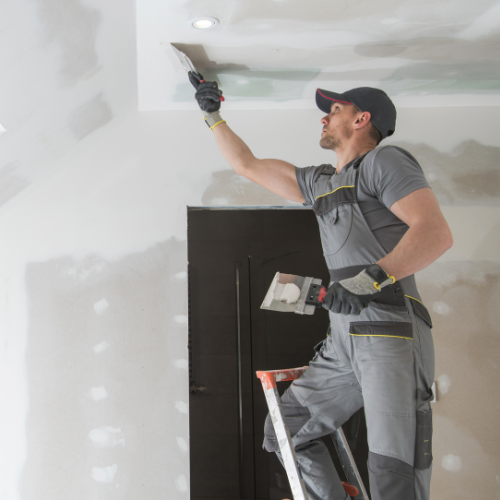 Home remodeling painter finishing an attic