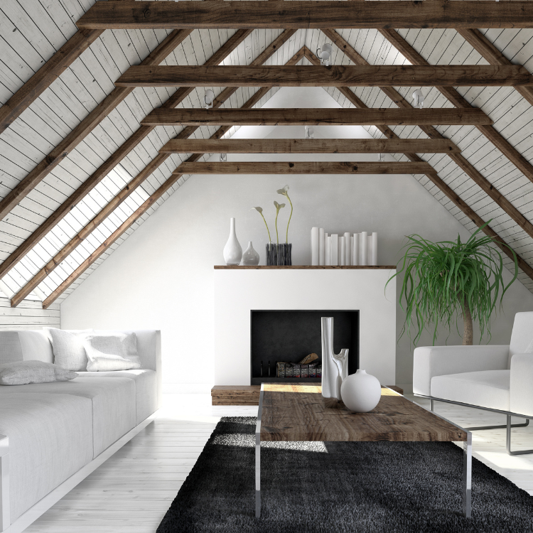A bright, minimalist attic living room with white furniture, wooden ceiling beams, a fireplace, and a dark rug.