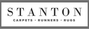 A black and white logo for stanton carpets runners and rugs.