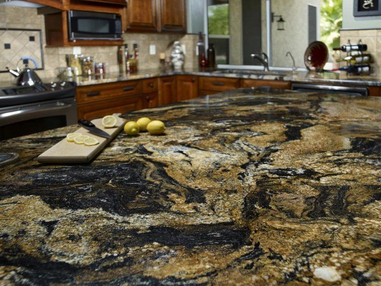 A kitchen counter with a cutting board and lemons on it