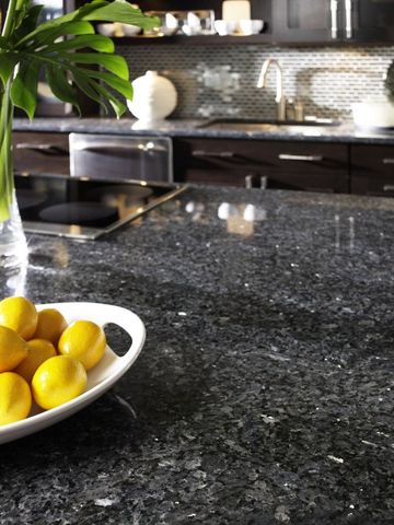 A bowl of lemons sits on a counter in a kitchen