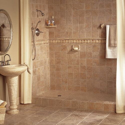 A bathroom with a walk in shower and a sink