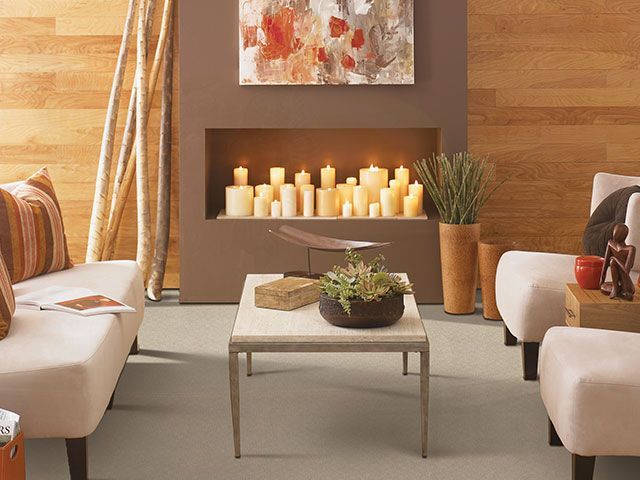 A living room with a fireplace filled with candles