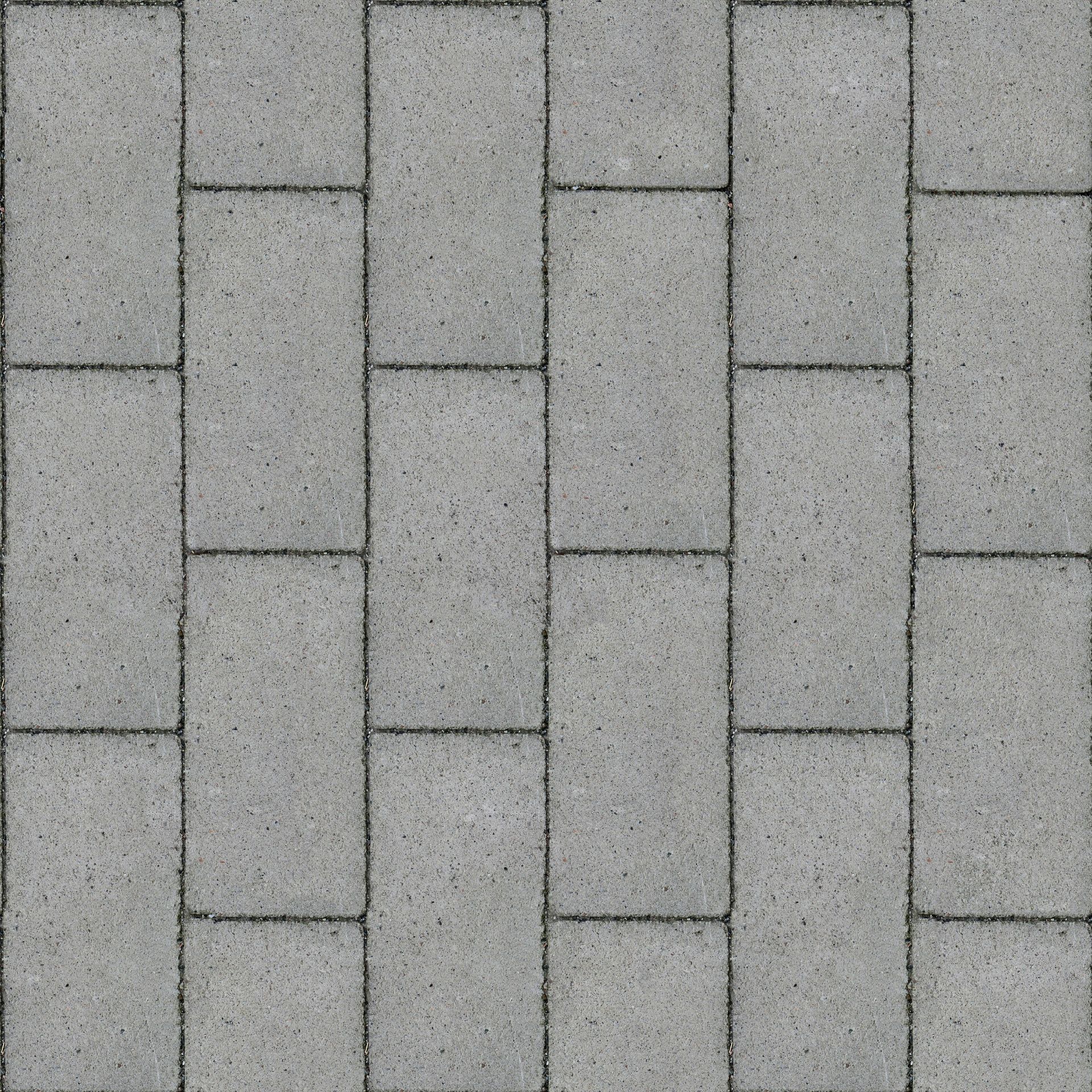 A repeating pattern of rectangular grey stone pavers arranged in a staggered running bond layout.