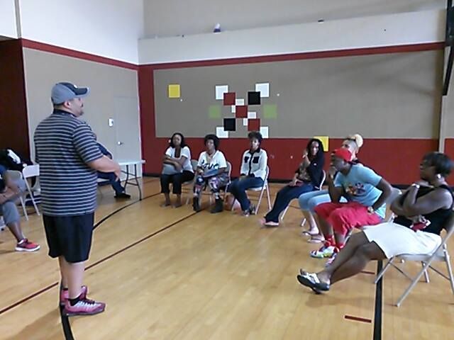 David Moore speaking in a small group setting sharing personal experiences and faith-based insights
