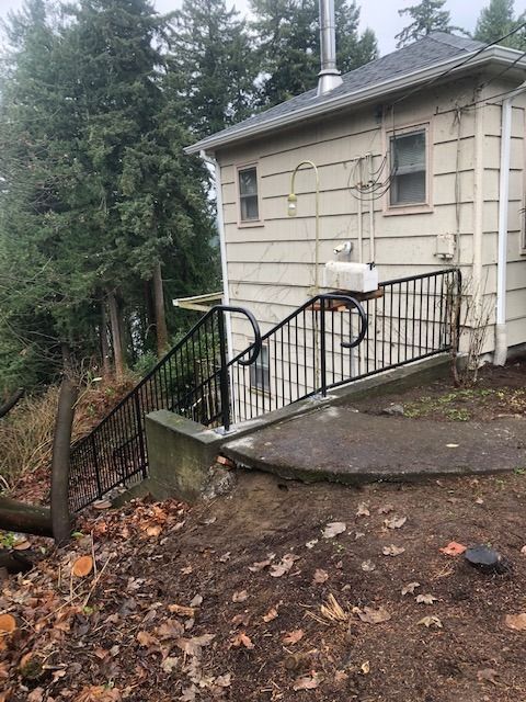 Outdoor welded steel handrail on sloped residential walkway