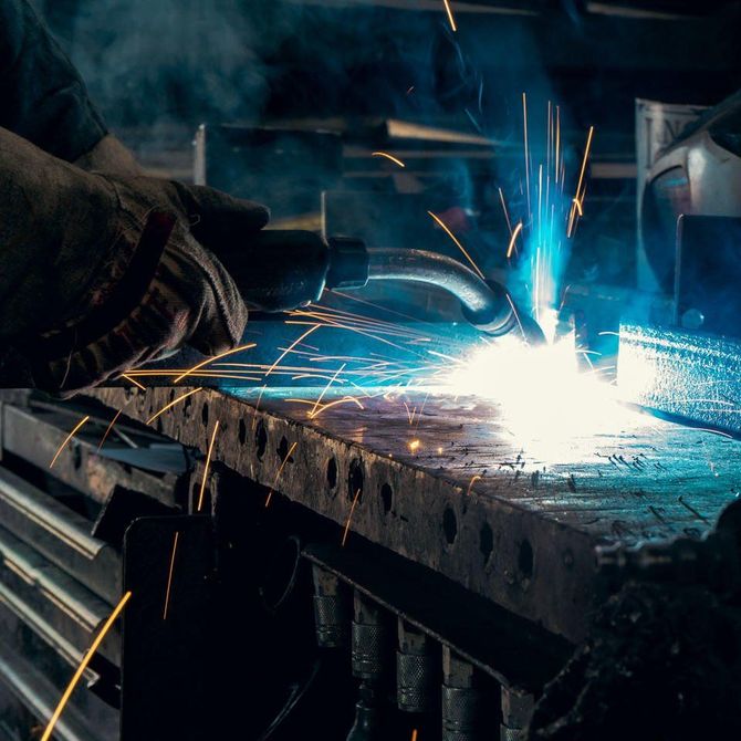 Close-up of welding process with sparks during custom steel fabrication work