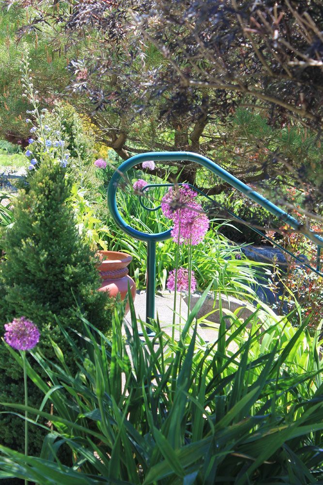 Decorative curved metal garden railing with custom fabrication detail