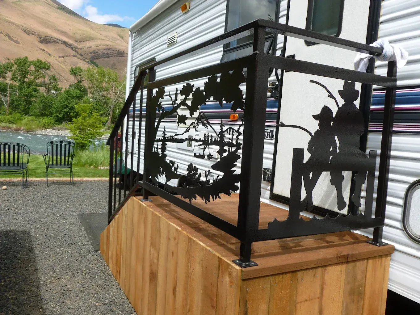 Custom welded steel railing with decorative cut-out panels on deck platform