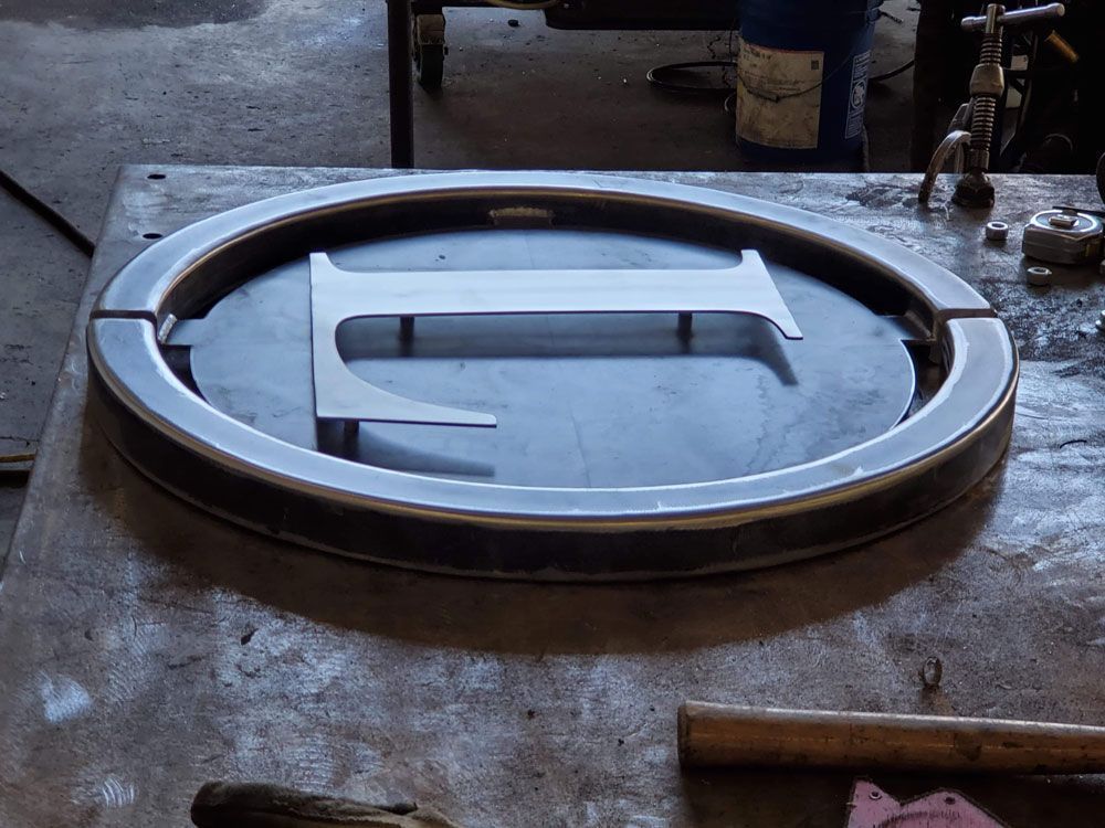 Custom fabricated circular steel component with precision cut design