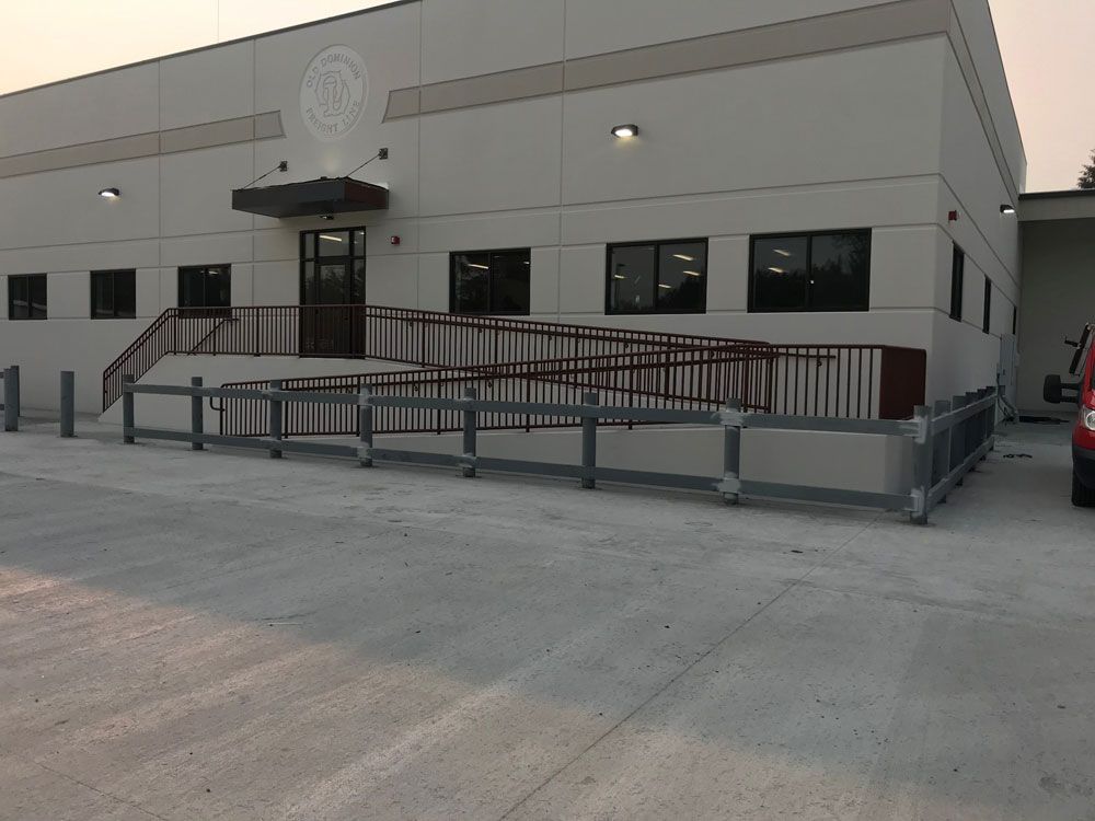 Commercial building ADA ramp with custom welded steel railing system